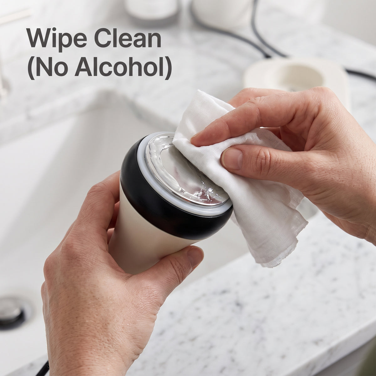 Cleaning the metal cavitation probe with a damp towel after treatment.
